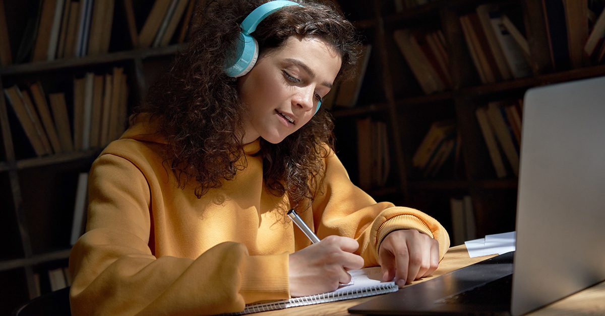 A challenge student studies while listening to music.