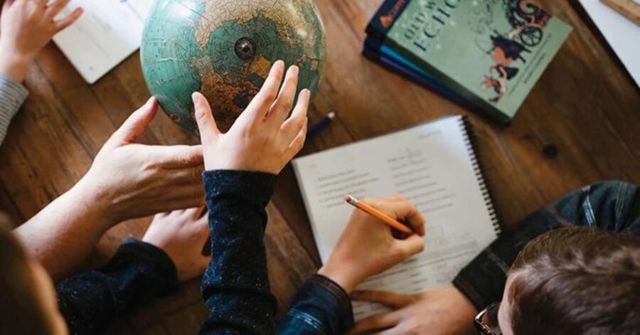 Photo of a family studying Classical Conversations material.