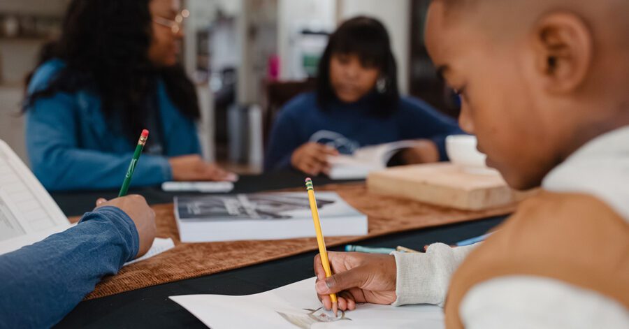A family working through their homeschool daily schedule together.