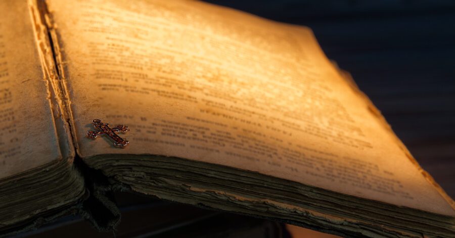 ancient Shakespeare book with golden cross pendant