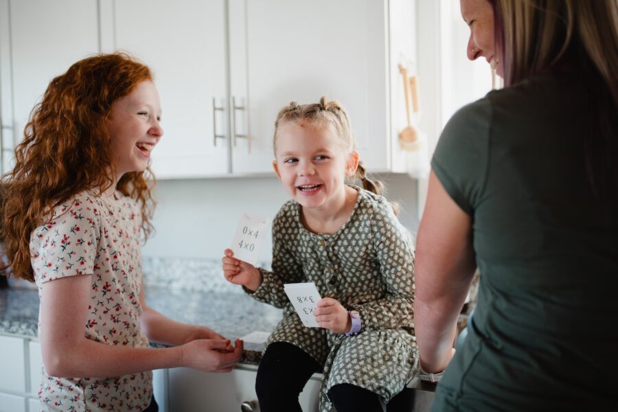 A homeschool family learning with the Classical Conversations math flashcards