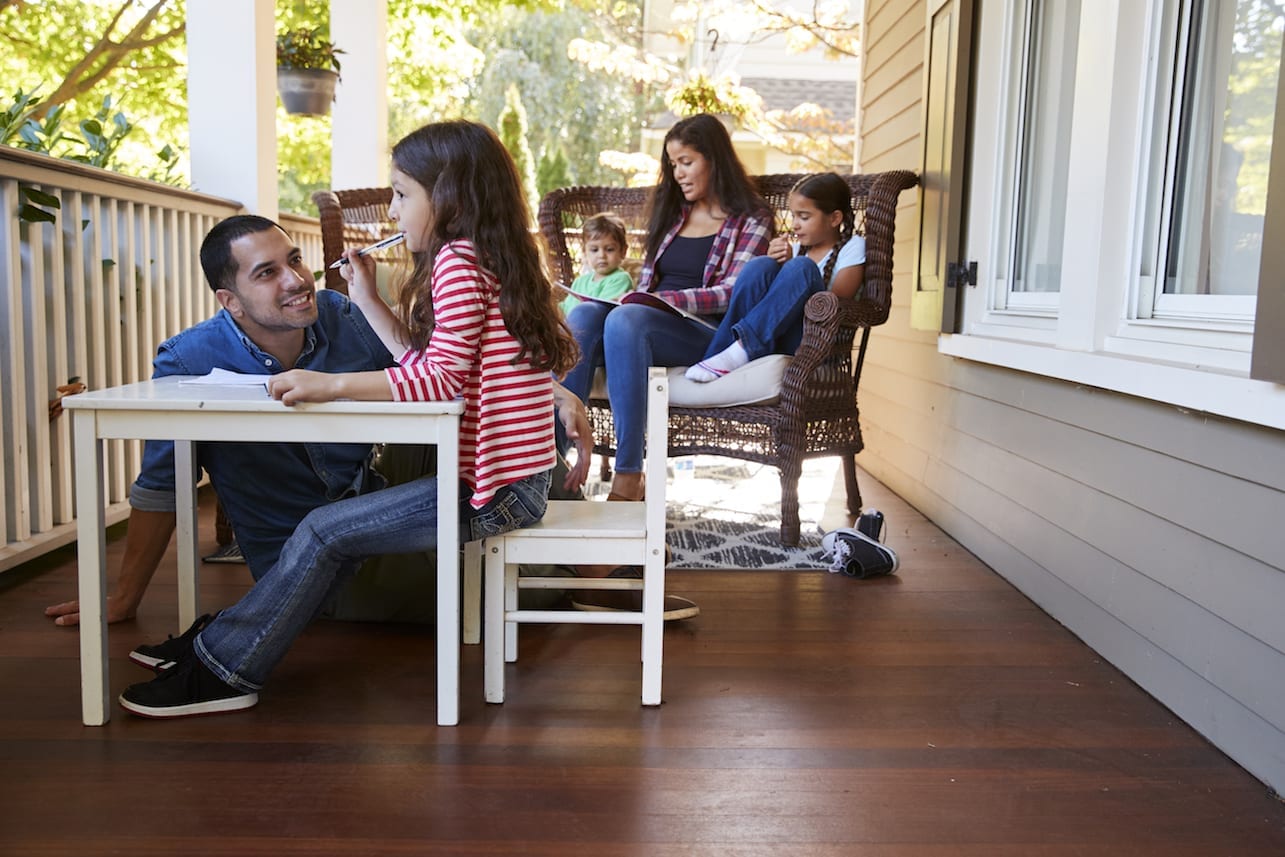 a family learning outside on the porch