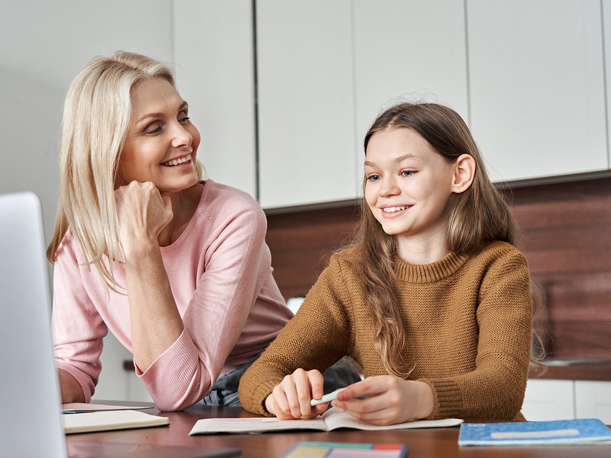 A mom and a daughter review their schoolwork together.