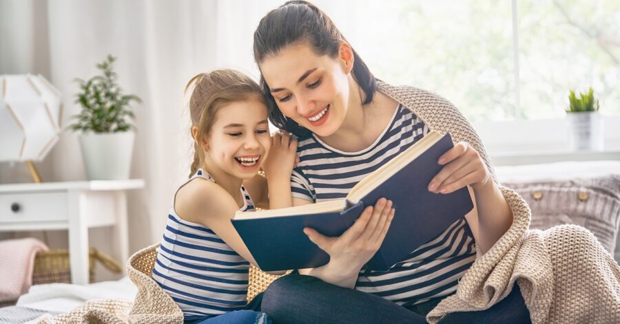 Mother and daughter reading from summer reading list
