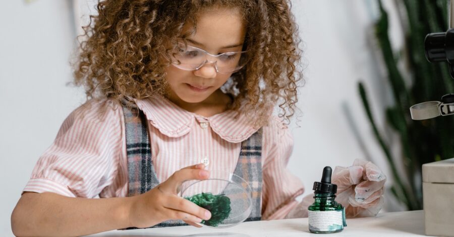 A girl studies science, conducts an experiment, and learns about the scientific method.