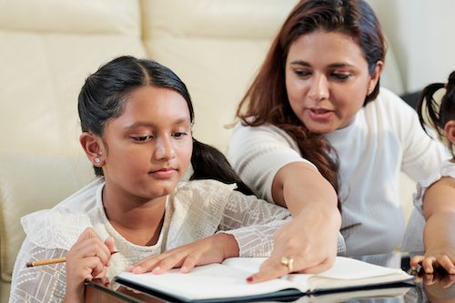 Homeschool mom and daughter studying at home