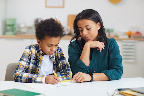 Homeschool mom and son studying at home
