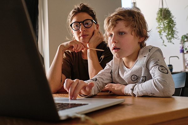 Child studying online on laptop