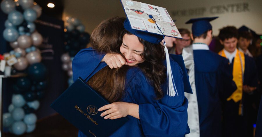 Parent and student hug during homeschool high school graduation