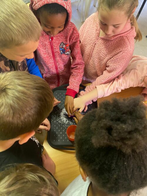 Homeschool students in Africa learning through a hands-on activity