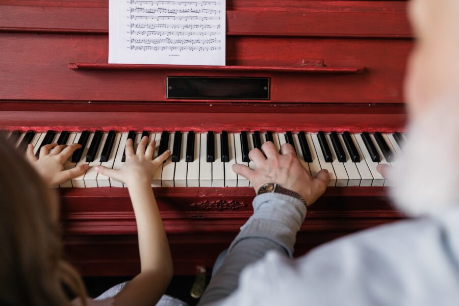 Homeschool music: Grandpa and granddaughter practice the piano.