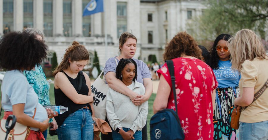 Homeschool families praying as they embrace educational freedom