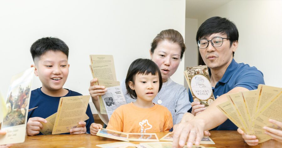 A homeschool family learning together at the table as part of their homeschool routine