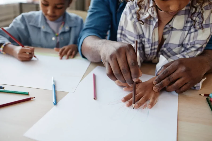 A family traces, draws, and copies.