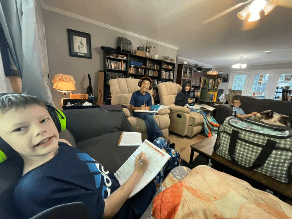 A homeschool family doing schoolwork in the livingroom.