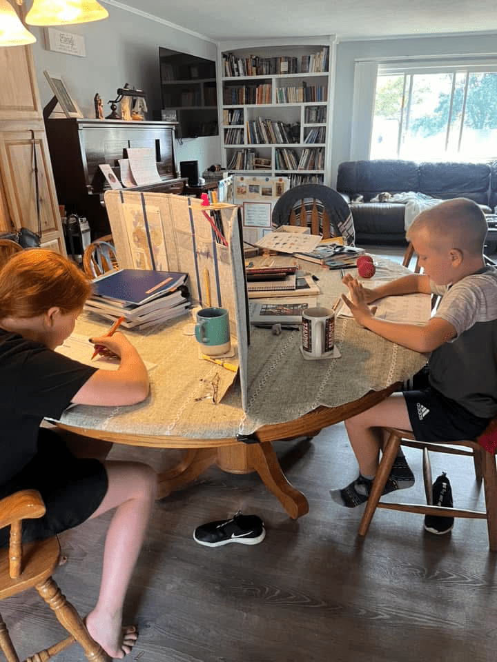 Homeschoolers working at the kitchen table.