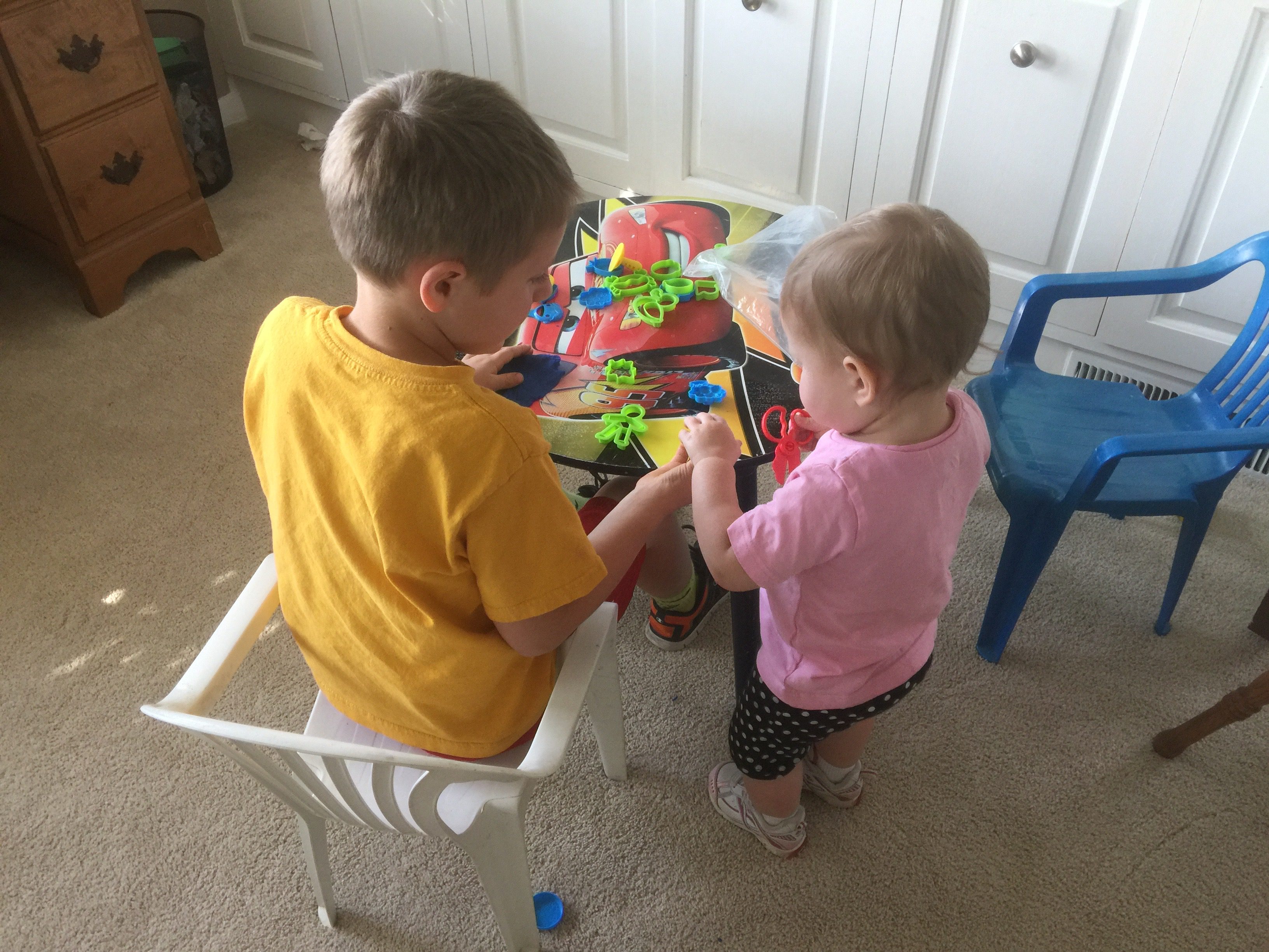 Two young children playing at a small table.