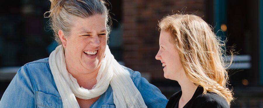 Homeschool mother and daughter looking at each other and laughing