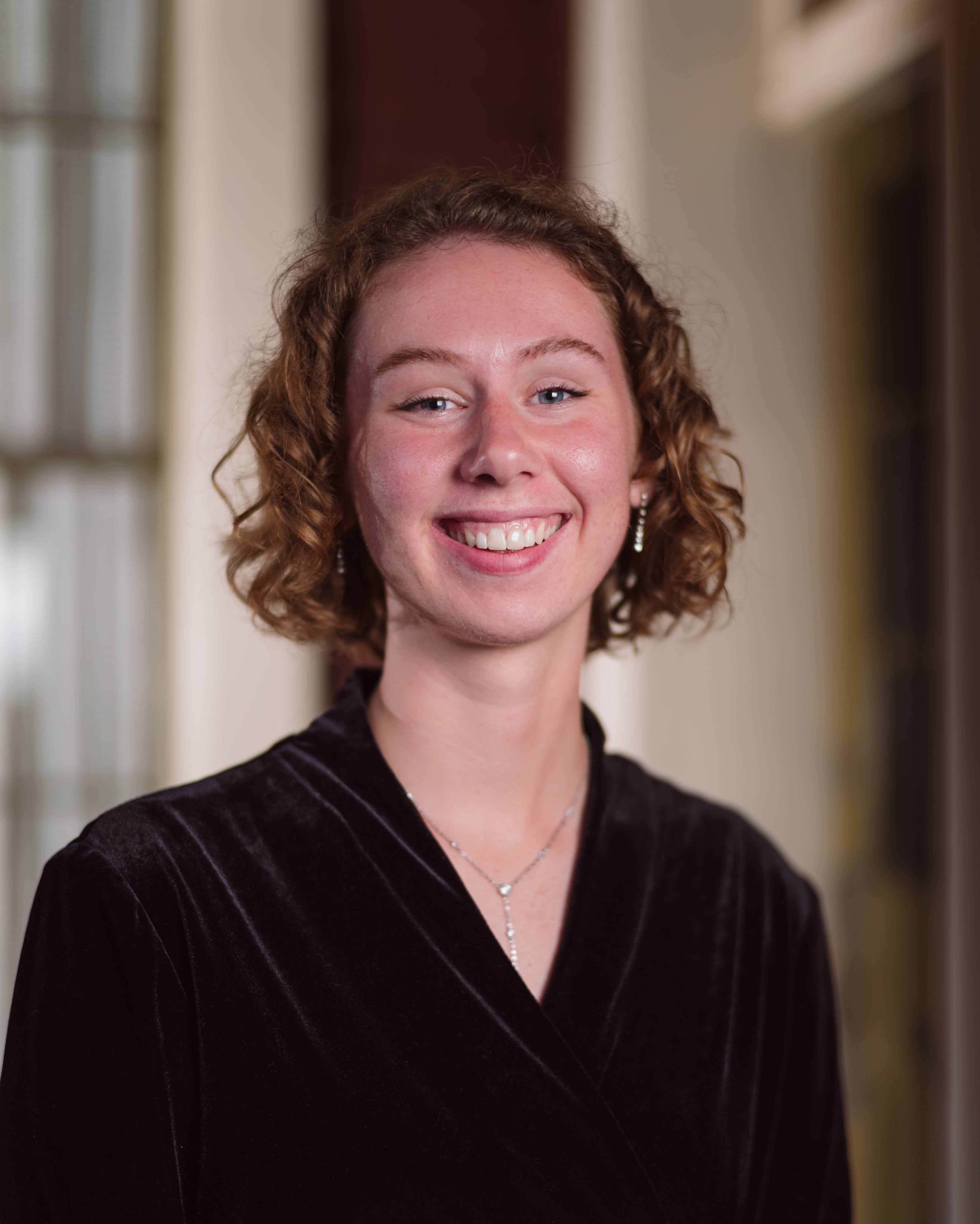 Headshot of young woman in black shirt. Regina Gravrok Homeschool Partnership Manager for CLT