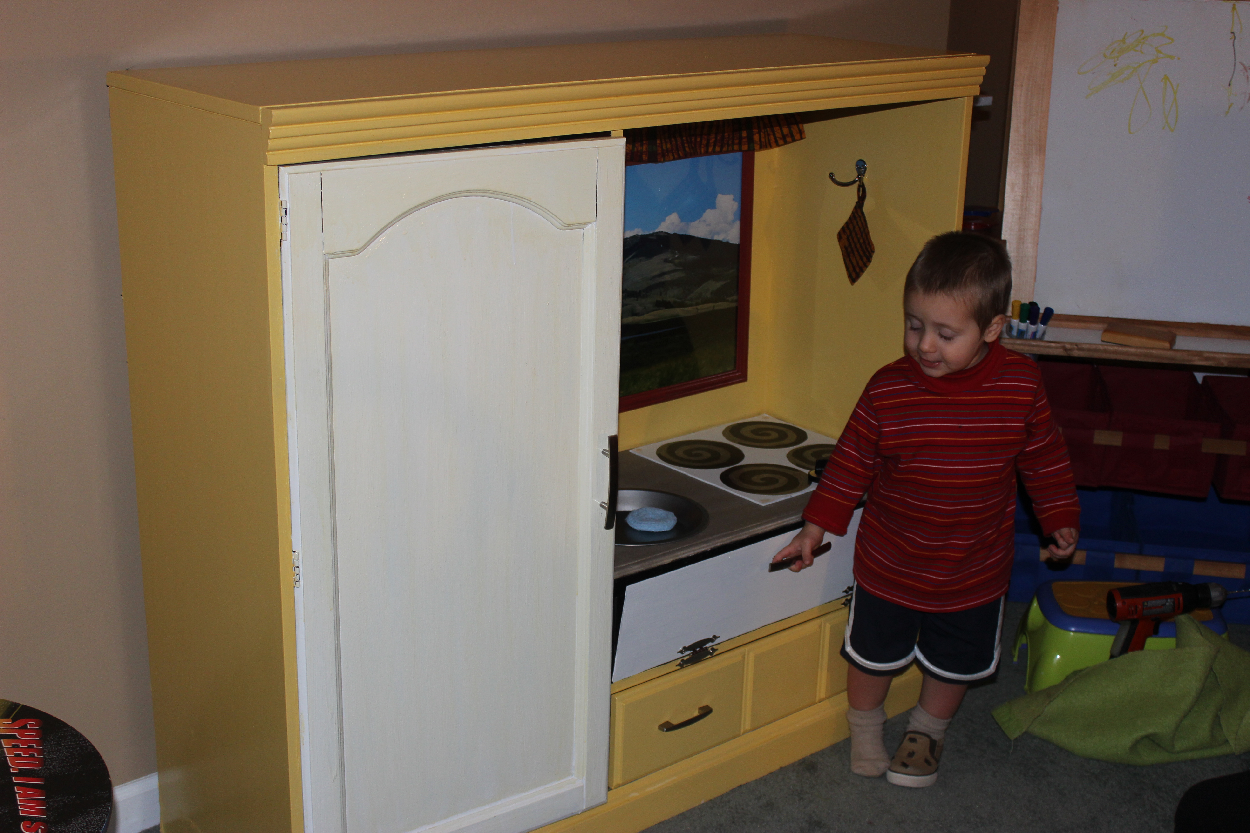 Homeschool toddler at his play kitchen.