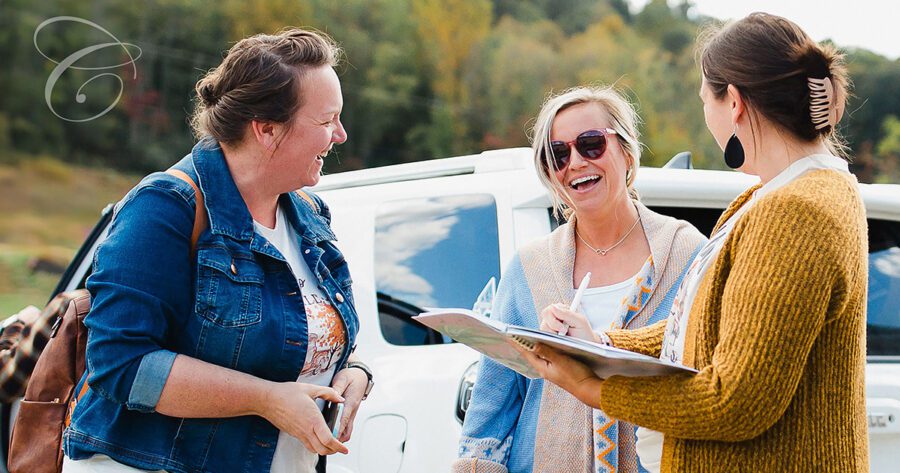Three women laughing and talking