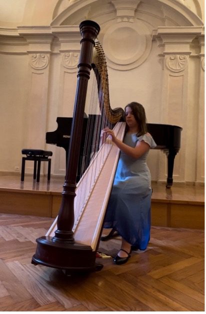 Homeschool student playing the harp