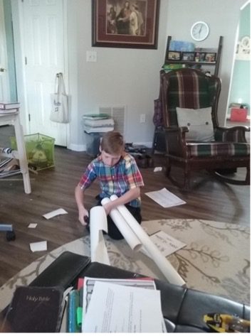 Homeschool student builds a paper bassoon to practice the keys.