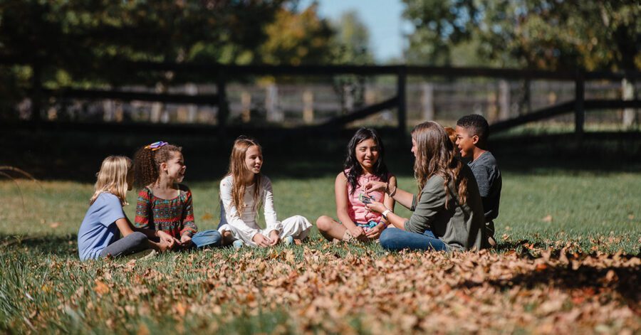 A group of homeschool students learning outside.