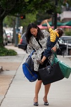 Homeschool mom carrying her child and all the bags