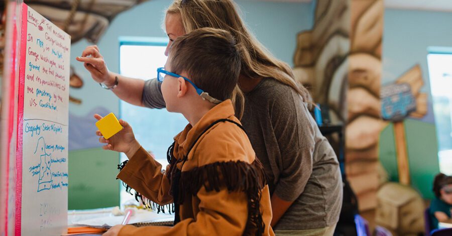 A homeschool CC tutor and student practicing new grammar in community