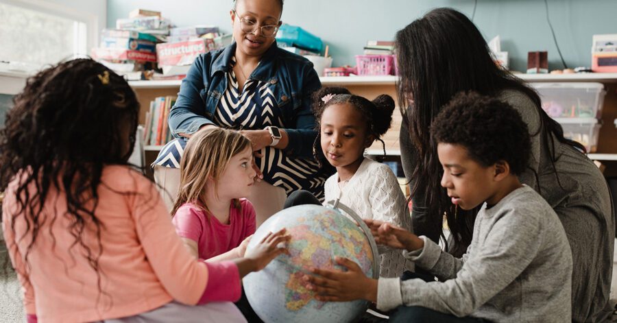 Foundations class looking at a globe