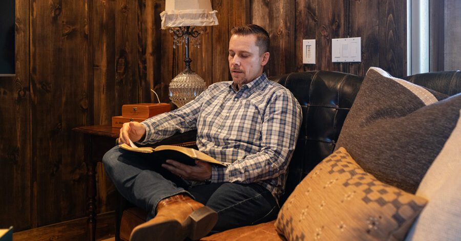 A homeschool father reading the Bible to help him raise mission-minded children