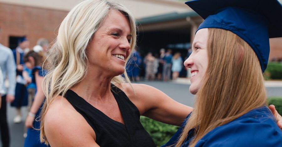 Mom and graduate discussing Is Classical Conversations worth it while hugging