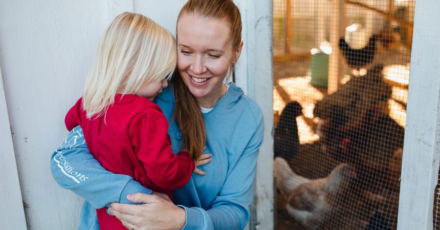 A mother holding her daughter, enjoying encouragement for homeschool moms.