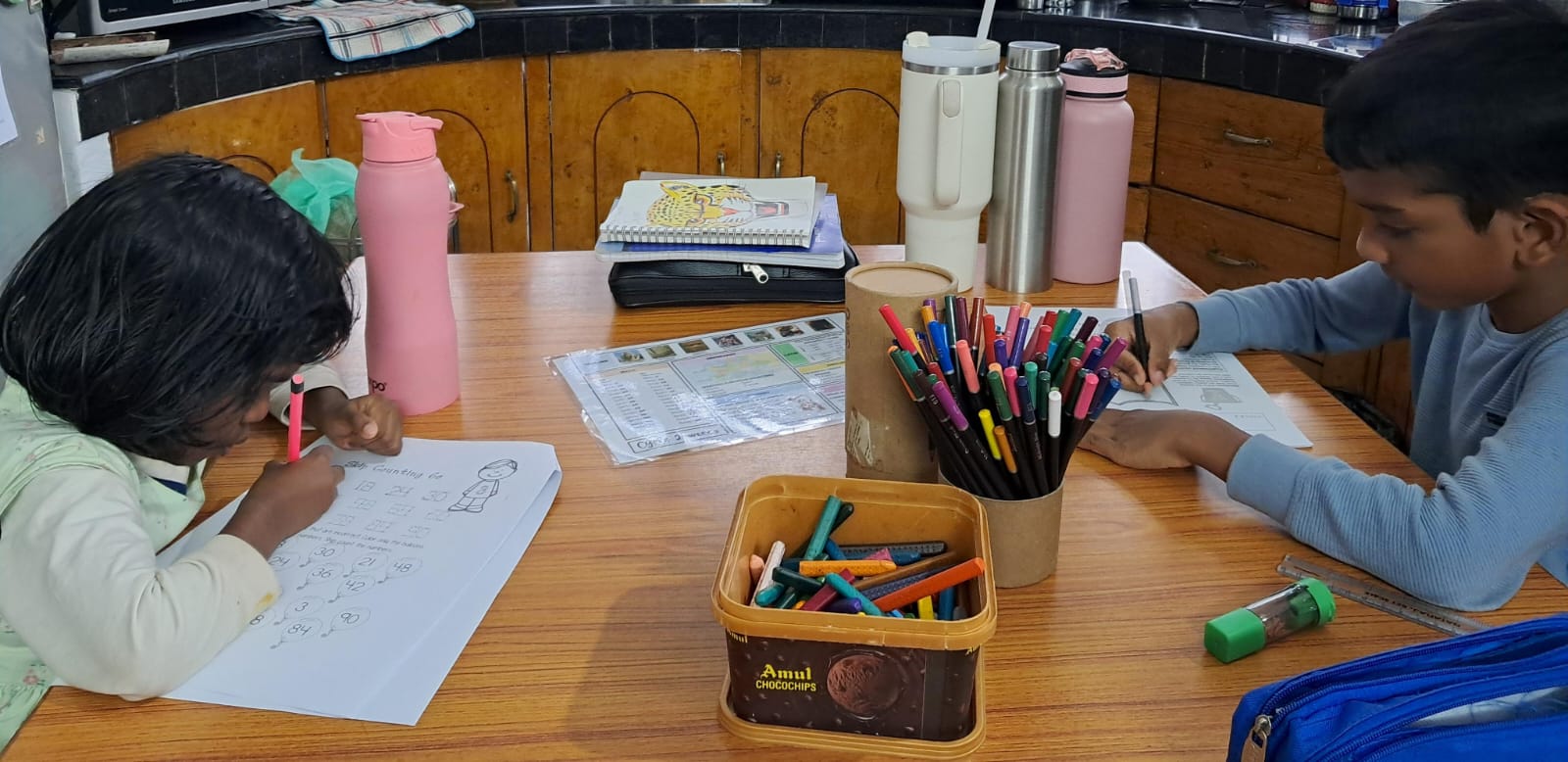 children learning at the table through classical education in India