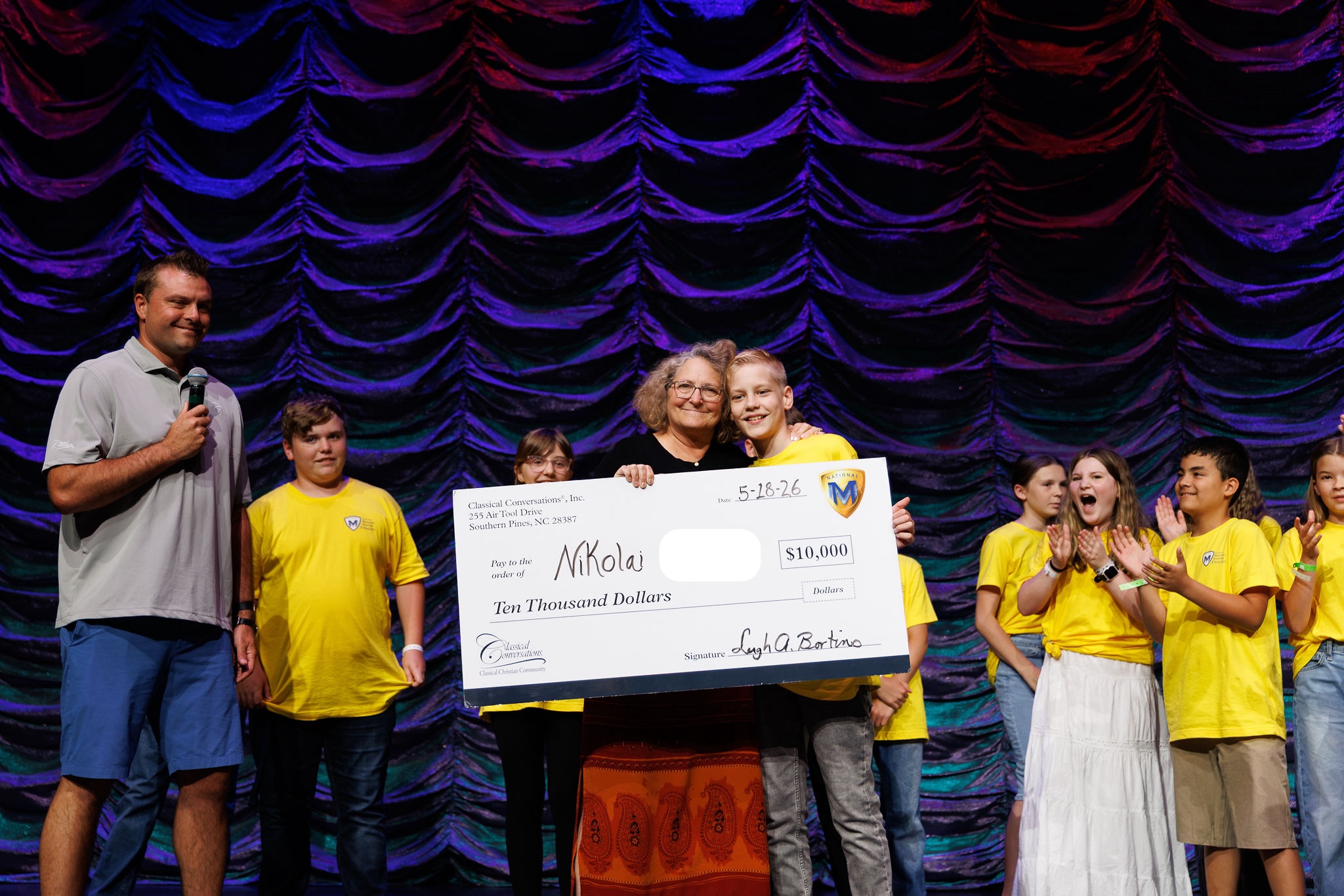 Leigh Bortins awards Nikolai with the National Memory Master scholarship