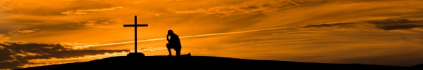 person kneeling at the cross at sunset, Samaritan's Purse