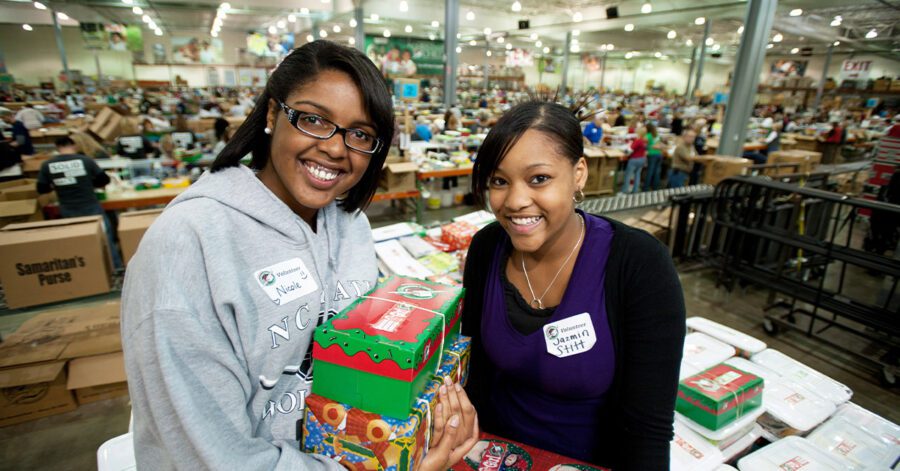 Two homeschool teens doing community service through Operation Christmas Child